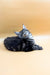 Fluffy gray tabby Maine Coon kitten lying on its side, looking cute and curious