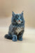 Fluffy gray Maine Coon kitten with bright blue eyes sitting upright, perfect for pet lovers