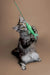 Gray tabby cat playing with a green string toy for Maine Coon kittens