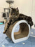 Long-haired tabby Maine Coon kitten relaxing on a stylish curved scratching post