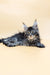 Fluffy gray Maine Coon kitten lying down with a curious expression for Sharm product