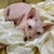 Hairless Sphynx kitten with big eyes cozy in white fabric for Stephen cat lovers